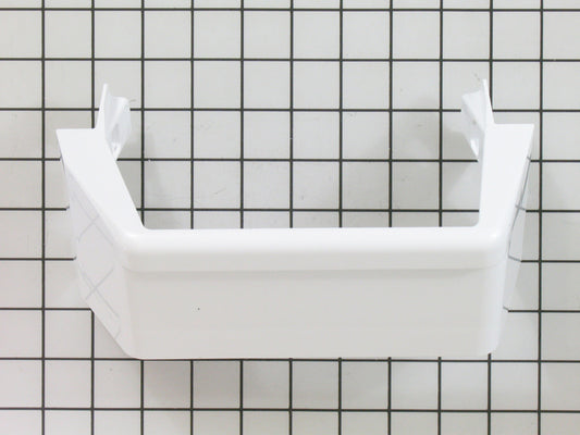 A white Whirlpool refrigerator door shelf trim against a checkered background.